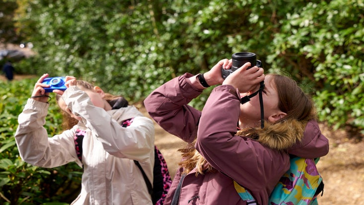 Children taking photos at Claremont Landscape Garden Surrey